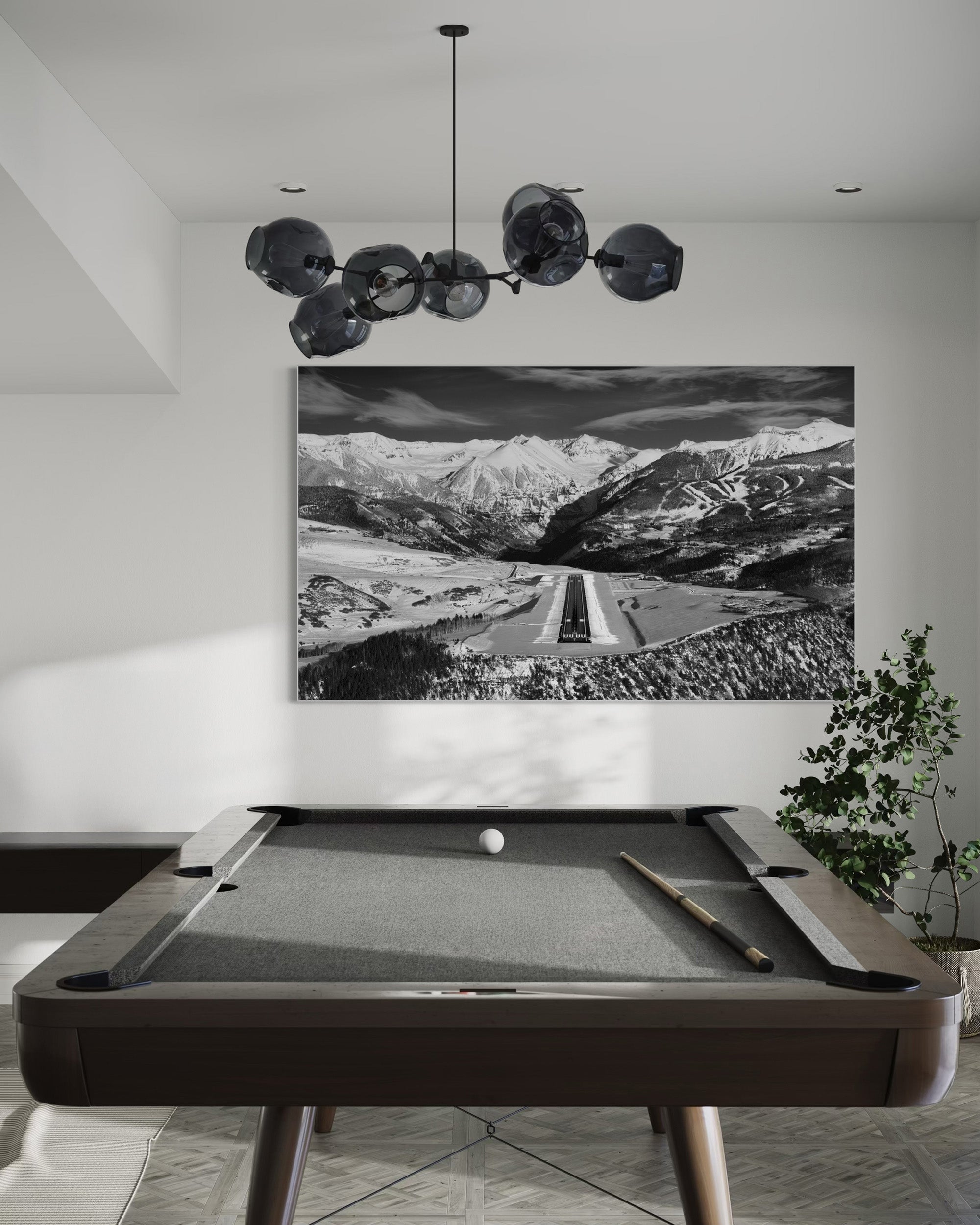 A framed fine art print of the telluride runway in a game room.