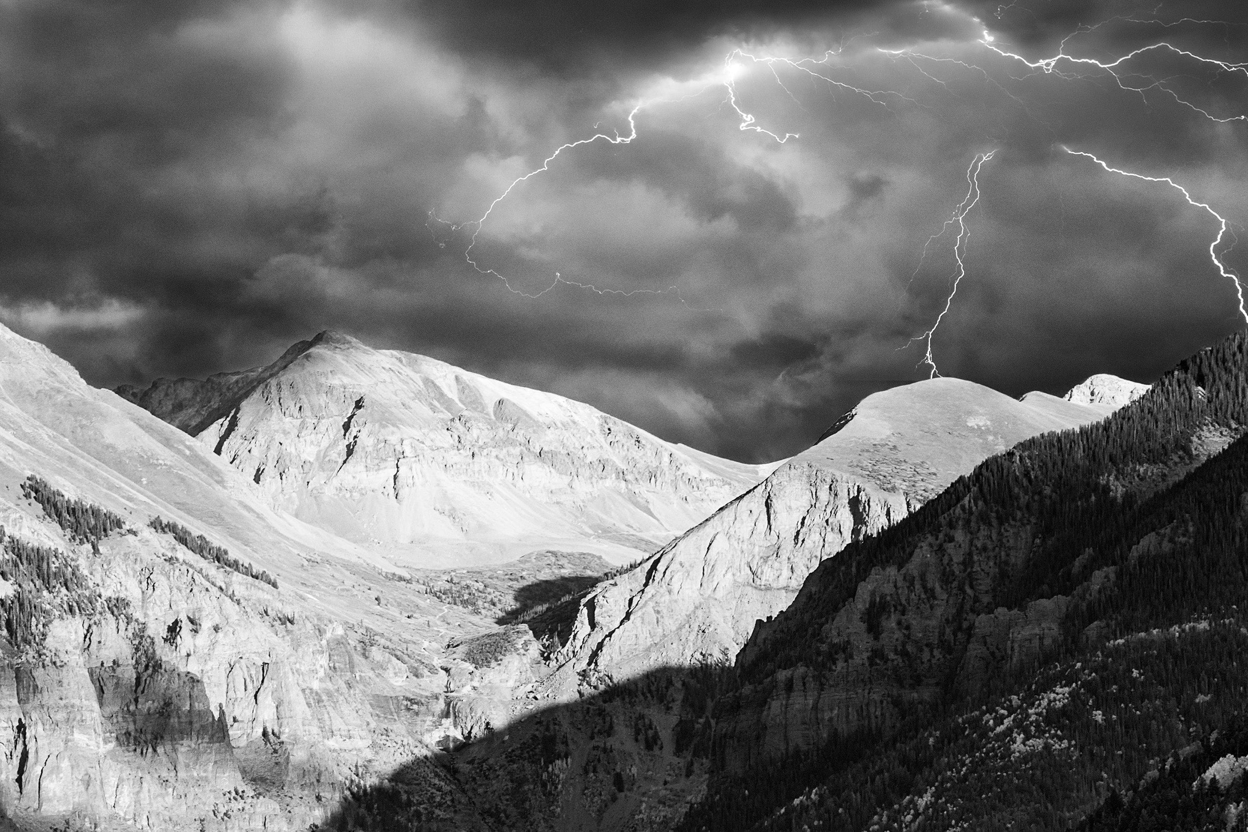 Ajax Mountain landscape in telluride with dramatic clouds and lightning during a storm.