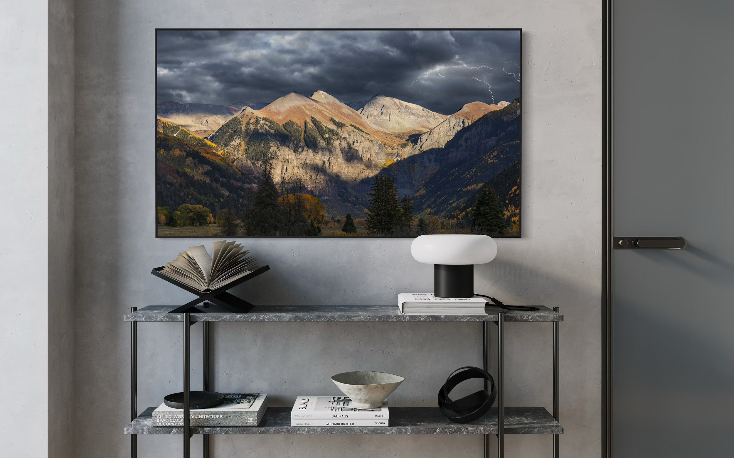 Photograph of telluride landscape photo mounted on a wall displaying a Telluride mountain landscape, with a shelf 